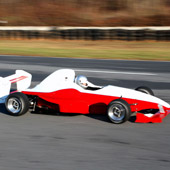 Right view of the F1000 race car from Philly Motor Sports racing on a Formula B outdoor track