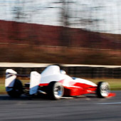 Rear view of the Philly Motor Sports F1000 race car speeding away on the outdoor track