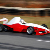 F1000 race car speeding down the pavement with blurred background