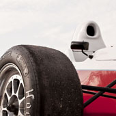 large image of the wheel of the F1000 race car with the cockpit in the rear of the image